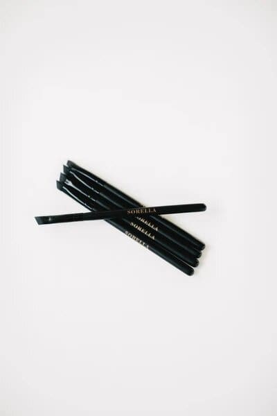 A group of black pencils on top of each other.