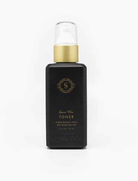 A bottle of facial oil with black label