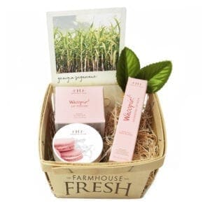 A basket of products with a plant in the middle.