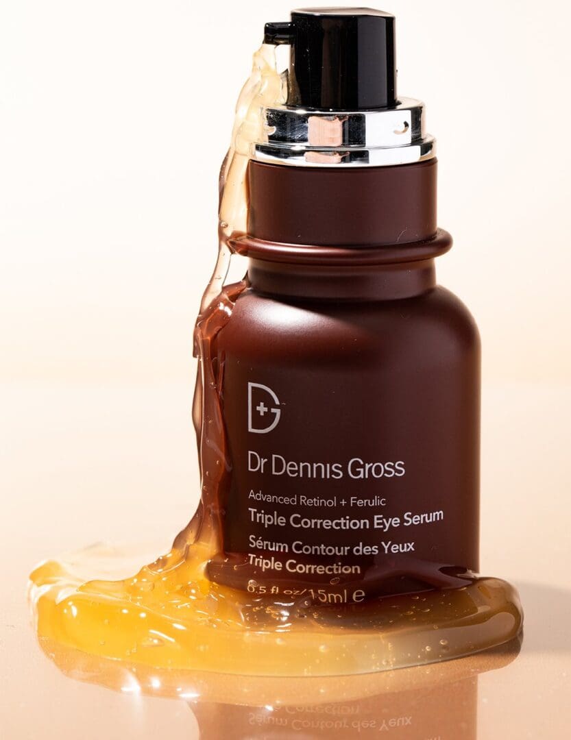 A bottle of dr. Dennis gross skincare on top of some liquid
