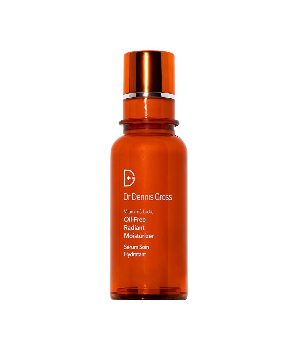 A bottle of serum with an orange lid.