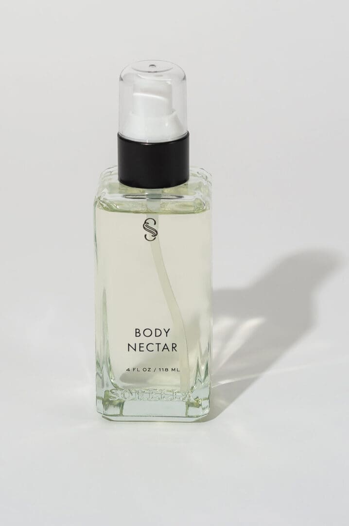 A bottle of body nectar is sitting on the counter.
