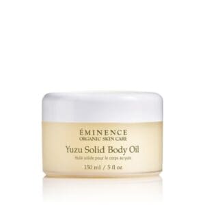 A jar of body oil sitting on top of a table.