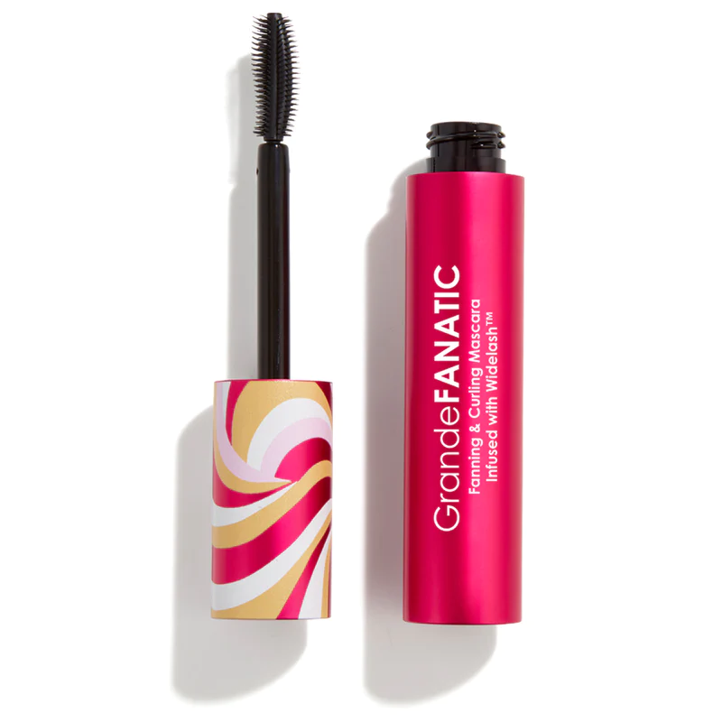 A tube of mascara next to the container.