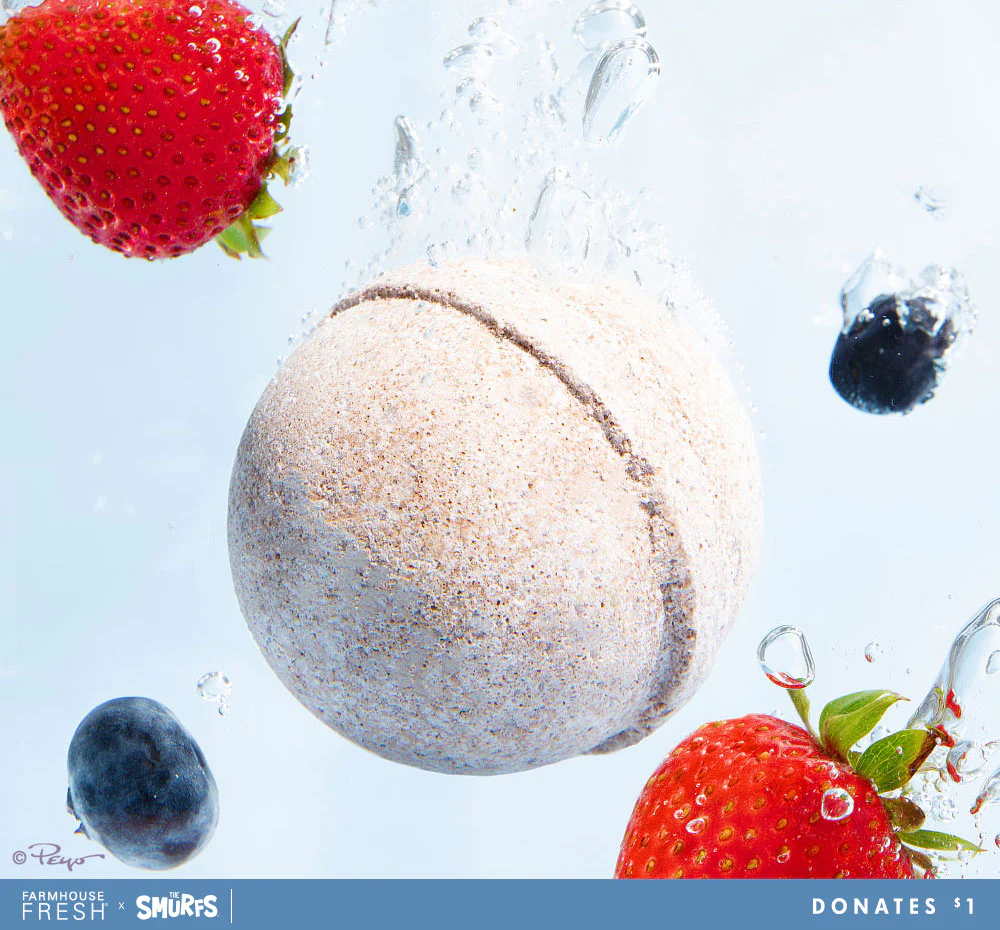 A tennis ball floating in the water with berries.