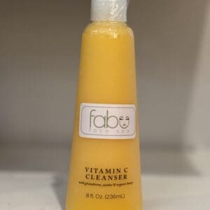 Vitamin C cleanser bottle on shelf.